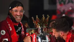 Jurgen Klopp holding the Premier League trophy