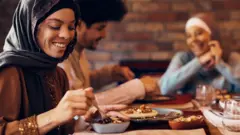 Three people at an iftar table