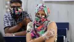 A woman waiting in the observation room after being inoculated with a dose of the Covishield AstraZeneca-Oxford's Covid-19 vaccine at the centre.