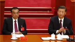 Chinese President Xi Jinping (R) reacts next to Premier Li Keqiang (L) during the closing ceremony of the 20th National Congress of the Communist Party of China (CPC) at the Great Hall of People in Beijing, China, 22 October 202