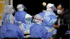 Medical staff in Hazmat suits