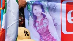 A protester holds up banner with an image of a female anti-coup demostrator, Mya Thwe Thwe Khine