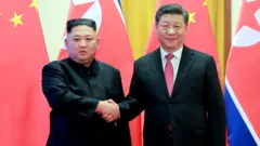 Kim Jong-un and Xi Jinping shakes hands in Beijing (Jan 2019)