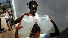 Girls carrying water in Haiti