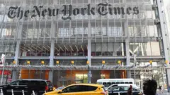 In this file photo a man holds his smartphone in front of the New York Times building on September 6, 2018 in New York