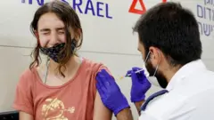 An Israeli girl receives a dose of the Pfizer/BioNTech Covid-19 vaccine