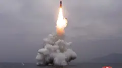 What appears to be a submarine-launched ballistic missile (SLBM) flies in an undisclosed location in this undated picture released by North Korea's official news agency