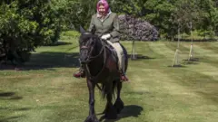 The Queen rides in the grounds of Windsor castle