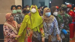 Relatives of people on Sriwijaya Air flight SJ 182 arrive at the crisis centre in Soekarno Hatta Airport, on 9 January 2021 in Jakarta, Indonesia