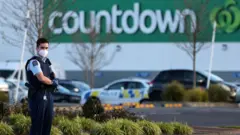 Armed police patrol the area around Countdown LynnMall