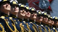 Servicewomen march during a Victory Day military parade in Red Square marking the 75th anniversary of the victory in World War II, on June 24, 2020 in Moscow,
