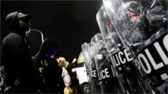 Police faceoff off with a protester