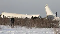 Emergency and security personnel are seen at the site of a plane crash near Almaty, Kazakhstan, December 27, 2019
