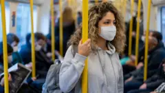 Passengers on a train in face masks