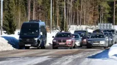 There is no heavy traffic at the border crossing between Russia and Finland but Russians are steadily flocking to cross the border
