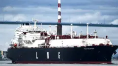 The LNG tanker Flex Volunteer, cruises near the Saint-Nazaire bridge over the Loire estuary, on April 12, 2022.