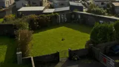 A general view of the former site of the Bon Secours Mother and Baby home and the memorial garden where it is believed 796 children are buried can be seen on February 21, 2024 in Tuam, Ireland.