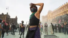 A woman gestures during a protest outside the National Palace