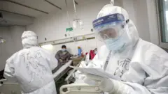 A medical worker in protective suit