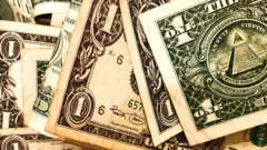 Stock image of a pile of one dollar notes