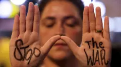 A demonstrator in Tel Aviv shows her hands with 'Stop' written on her right palm and 'The War' written on her left palm, as families and supporters of hostages kidnapped during the 7 October 2023 attacks by Hamas, protest against the government and to demand their immediate release, amid the ongoing conflict in Gaza between Israel and Hamas 17 October 2024