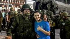 Woman poses for picture with Wagner Group troop