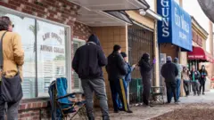 Customers queue outside a LA county gun shop