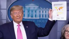 Trump holds print-out of map showing countries rated as best-equipped to cope with an epidemic