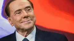 Berlusconi smiles at an event in 2018