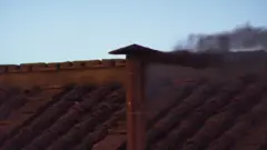 Black smoke emerges from the Sistine Chapel chimney