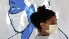 artist paints mural of healthcare worker in San Francisco