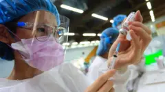 Medical workers prepare the Astra Zeneca vaccine, as the authority starts its mass vaccination programs, following a surge of domestic cases and deaths related to the Coronavirus, in New Taipei, Taiwan, on 15 June 2021.