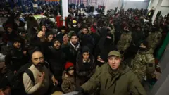 Migrants stay in the transport and logistics centre near the Bruzgi border point