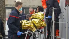 A Vietnamese pregnant migrant woman is evacuated