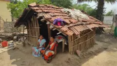 Women of Kanal Tola outside their period hut