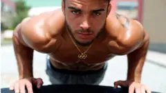 An athlete looks to the camera as he trains