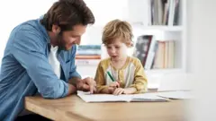 father helping his son with homework