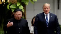 Kim Jong-un and Donald Trump talking in Hanoi