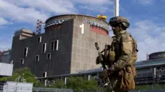 A Russian soldier patrols the territory of the Zaporizhzhia nuclear power plant on 1 May