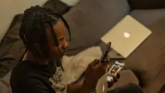 Naira Marley on im computer