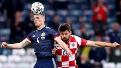 Scott McTominay heading a ball