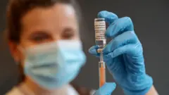 A pharmacist holding the vaccine