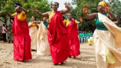 Female prisoners dance at the launch.