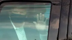 US President Donald Trump rides in front of the Walter Reed National Military Medical Center
