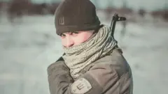 Olena Biletskyi holding a gun