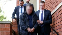 Police dey hold Scott Price for handcuffs