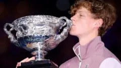 jannik sinner kisses the trophy