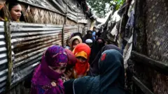 Rohingya family members gather as a part of religious ceremony in Kutupalong refugee camp in Ukhia near Cox's Bazar