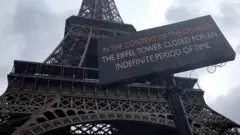 A sign notifies the closure of the Eiffel Tower. 14 March 2020