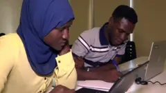 students in front of computer